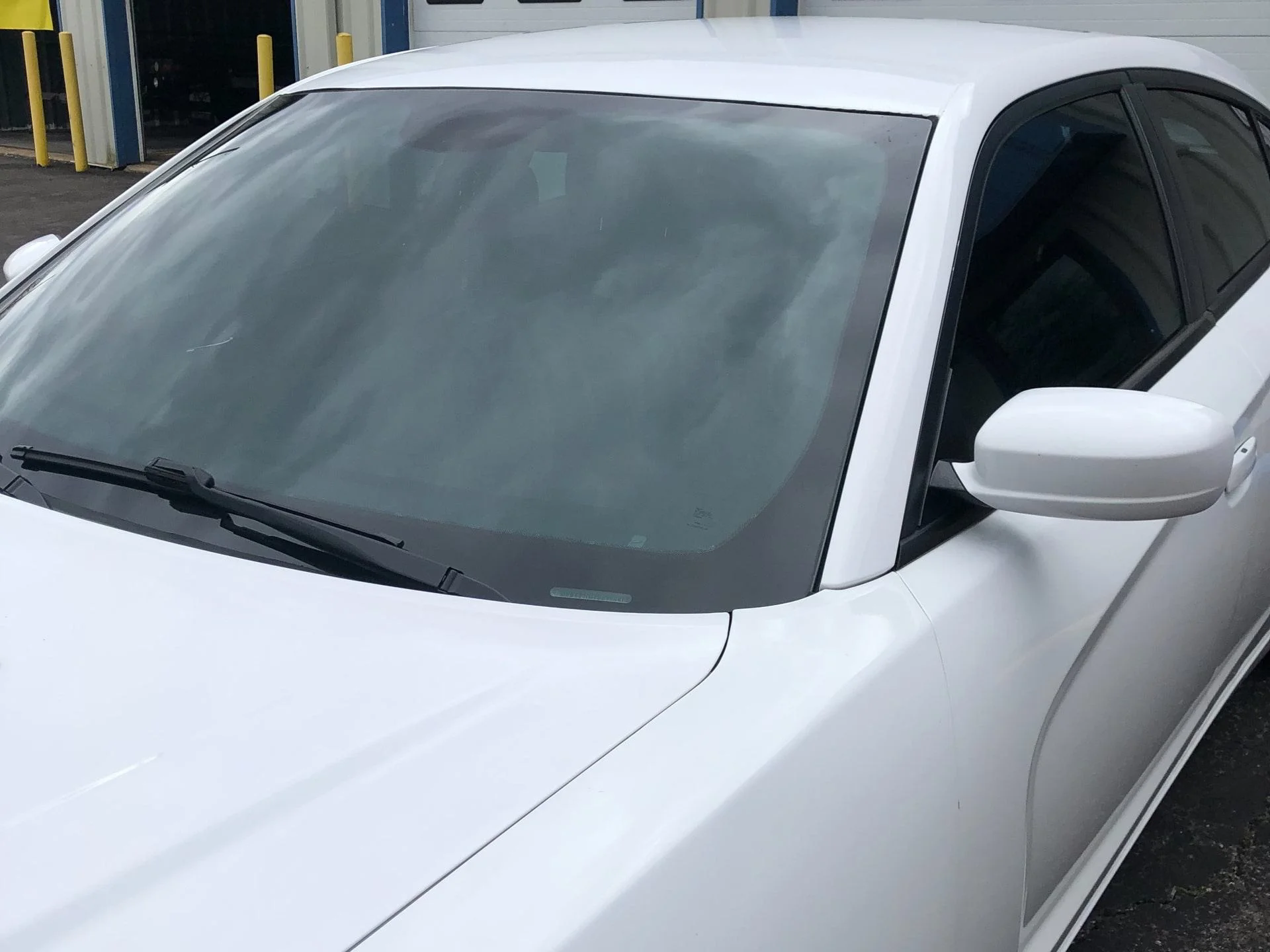 white car front windshield window tinting install dynamic detailing & tint odenton md